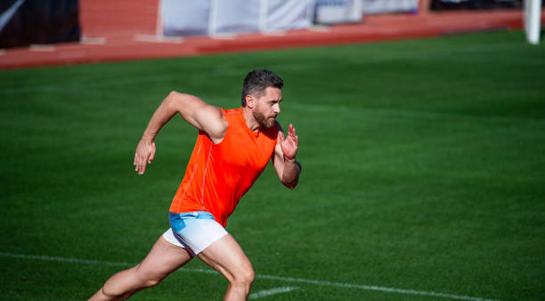 istock man sprinter running from start to finish with success and speed, sport 1464562033