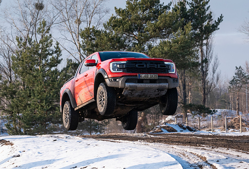 Berlin, Germany - 6th February, 2023: Ford Ranger Raptor jumping while driving on a road. The Ranger is one of the most popular pickup vehicles in Europe.