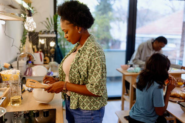 istock Beautiful African woman preparing breakfast 1464563460
