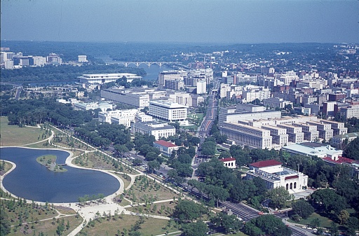 The Washington National Mall during the 1950's. The long, grassy National Mall is home to iconic monuments including the Lincoln Memorial and the Washington Monument. At the eastern end is the domed U.S. Capitol, and the White House is to the north. It's also flanked by Smithsonian museums, and its lawns and pathways are often crowded with school groups, joggers and softball teams. Nearby, the Tidal Basin reservoir is known for its blossoming cherry trees. Copyright has expired on this artwork. Digitally restored. Historic photos shows the U.S. Capitol in 1950 and its surrounding areas of Washington D.C.
