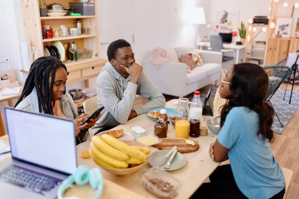 istock Group of young people sitting at the table 1464563808