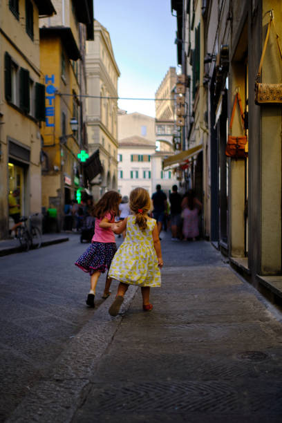 istock Two small sisters run to explore Florence Old town 1464567097