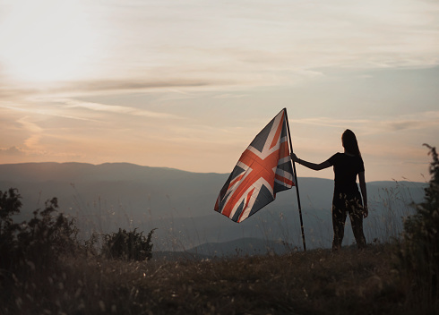 Proud woman holding the Great Britain flag