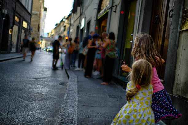 Family sightseeing trip in Florence, small sisters are having fun while exploring historical center of Florence