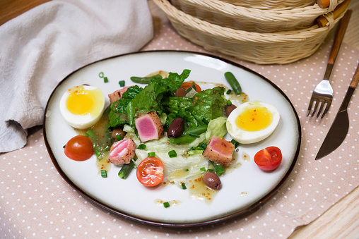 Nicoise salad is a famous culinary recipe made with fresh vegetables, boiled eggs, tuna, and olive oil. The salad is also dressed with lemon juice or wine vinegar.