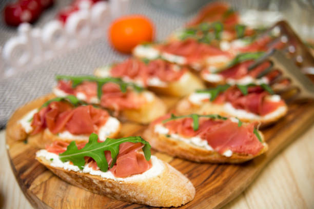 istock Bruschetta with prosciutto, arugula and mozzarella 1464569399