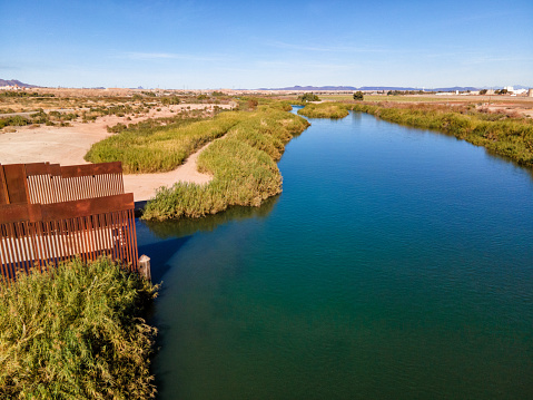 International Mexican Border Wall Terminates at the Colorado River Delta Between Algodones Mexico and Yuma Arizona in Drought Conditions in an Arid Climate