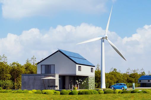 Modern house with solar photovoltaic roof panels and wind turbine. 3D generated image. Vehicle is custom modeled, generic and not based an any real model/brand.