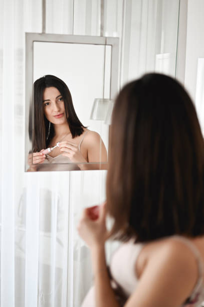 istock Woman doing her daily skincare routine at her bathroom. copy space. 1464571981
