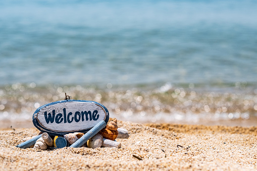 the beach and the sand have the word welcome
