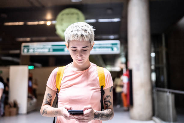 istock Young woman using the mobile phone in the subway station 1464577335