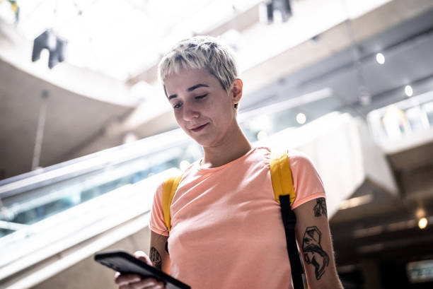 istock Young woman using the mobile phone in the subway station 1464577342