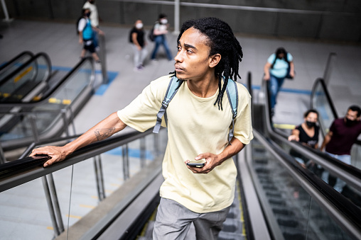 Young man on the escalator in the subway station