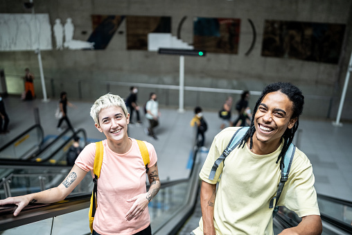 Portrait of friends on the escalator in the subway station