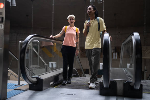 istock Friends talking on the escalator in the subway station 1464578393