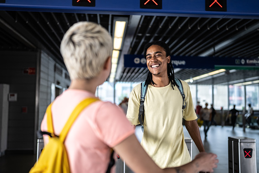 Friends greeting in the subway station