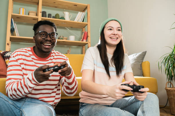 istock Happy couple gaming at home 1464578939