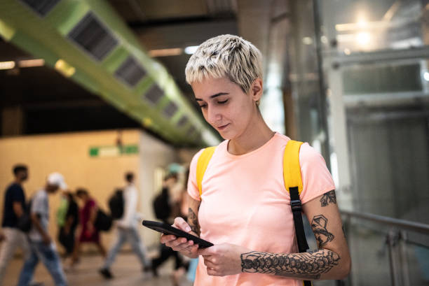 istock Young woman using the mobile phone in the subway station 1464579682