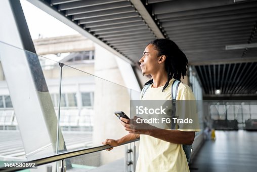 istock Contemplative young man looking through the window in the subway station 1464580892