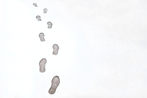 human footprints on snowy ground. Just snow and footprints.
