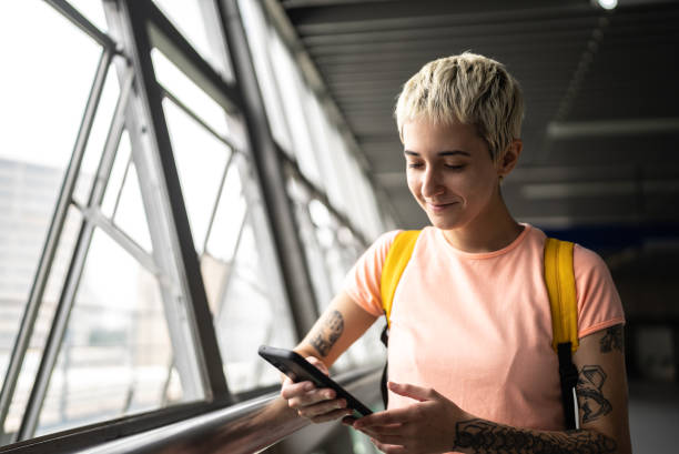 istock Young woman using the mobile phone in the subway station 1464580980
