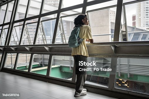 istock Contemplative young man looking through the window in the subway station 1464581016
