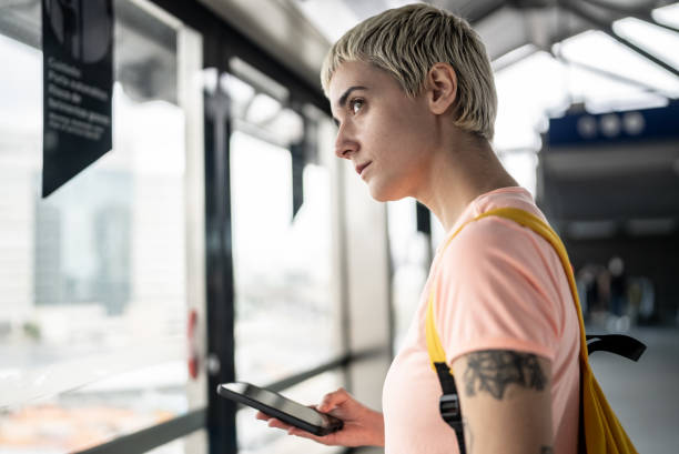 istock Young woman waiting for the train in the subway platform 1464581127