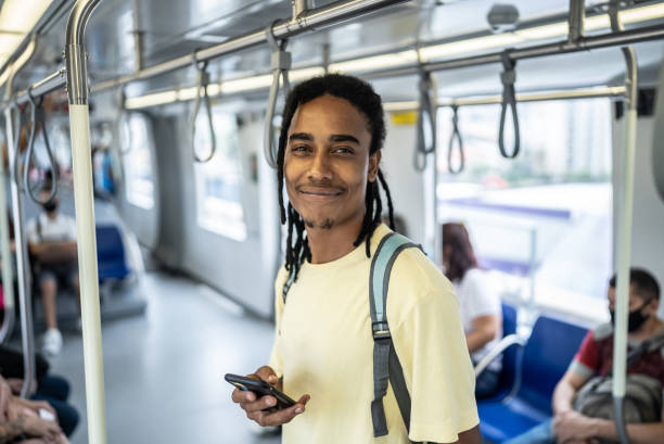 istock Portrait of a young man using the mobile phone in the train 1464581551