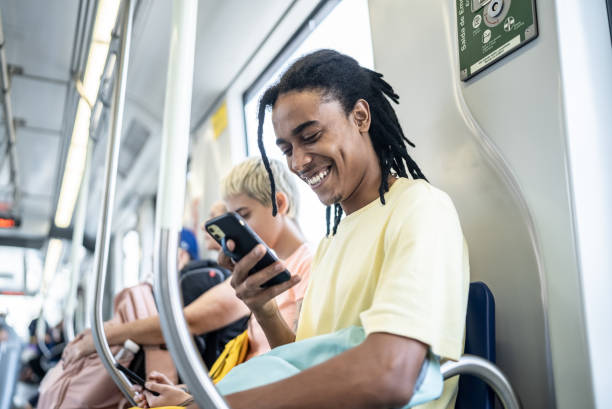 Young man using the mobile phone in the train