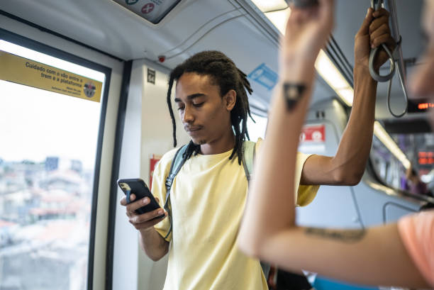istock Young man using the mobile phone in the train 1464581781
