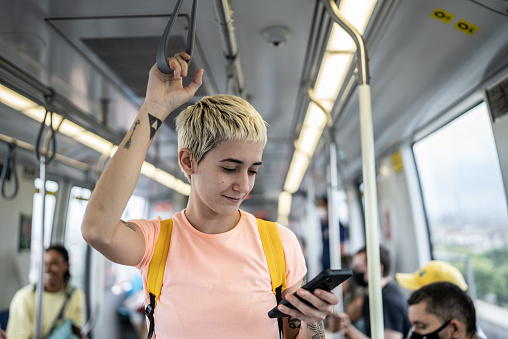 Young woman using the mobile phone in the train