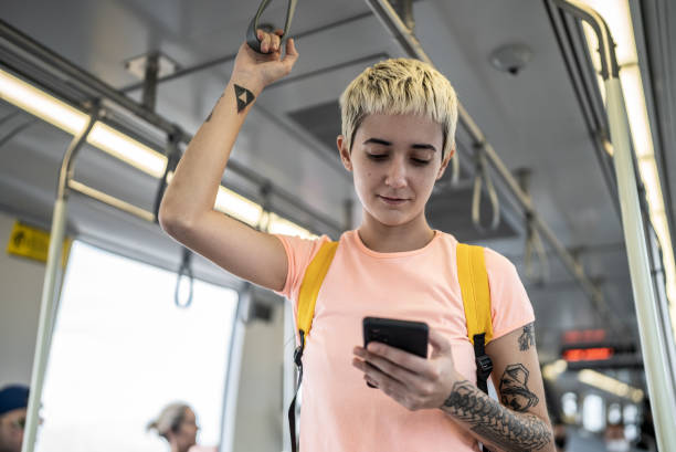 istock Young woman using the mobile phone in the train 1464582862
