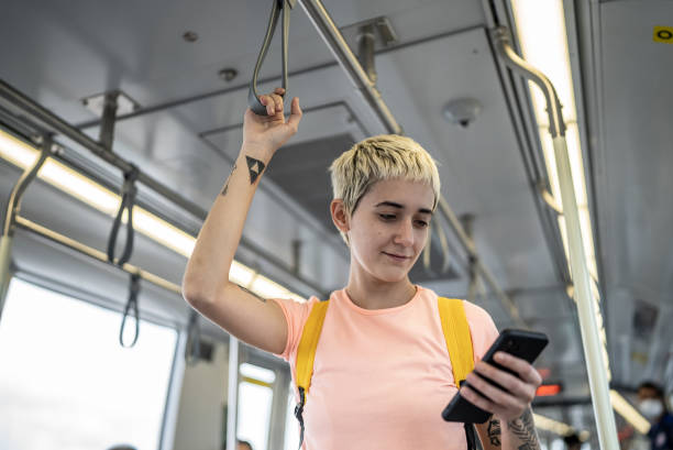 istock Young woman using the mobile phone in the train 1464582867