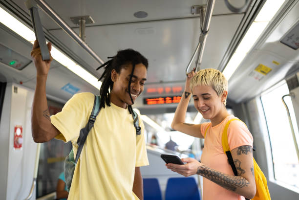 istock Friends using the mobile phone and talking in the train 1464582887