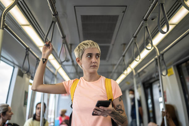istock Young woman using the mobile phone in the train 1464582940