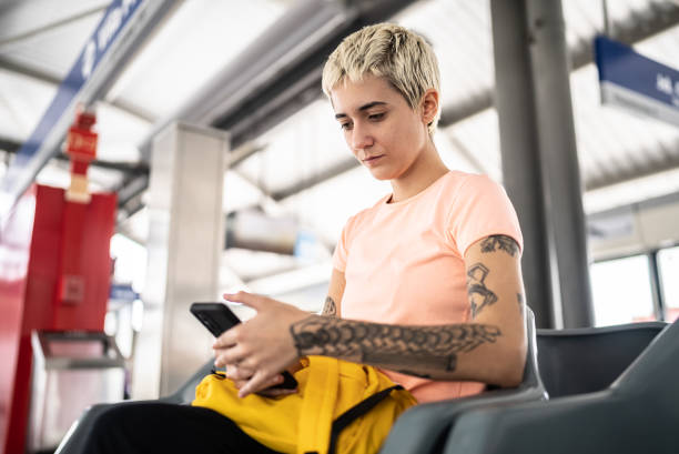 istock Young woman using the mobile phone in the subway station 1464582994