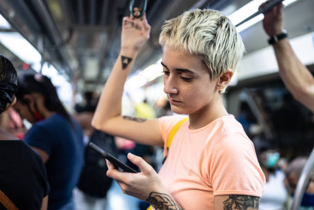 istock Young woman using the mobile phone in the train 1464583048