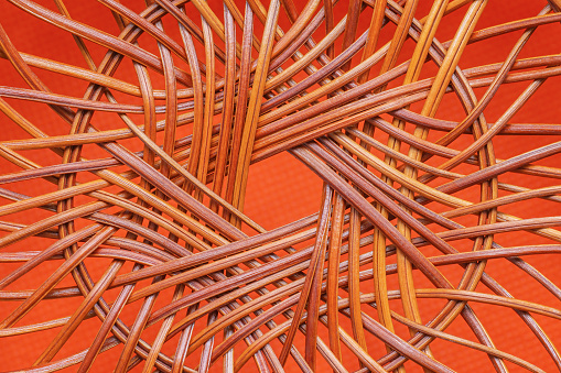 Wicker basket bottom isolated on orange background. Basketry. Traditional art and craft.