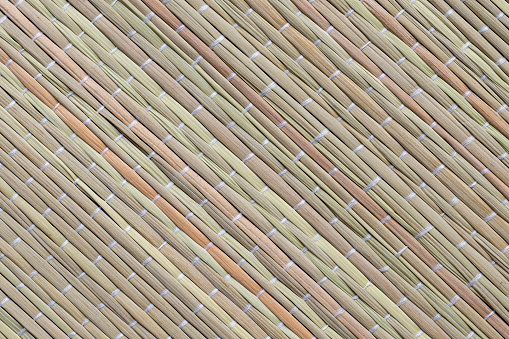 Straw beach mat texture. Closeup shot of beach and picnic blanket or yoga mat made of straw.