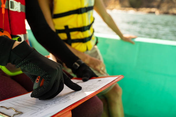 istock Marine biologist pointing to a data paper on a boat 1464588710
