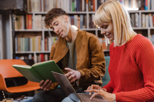 istock University students working together on a school project in the library 1464592033