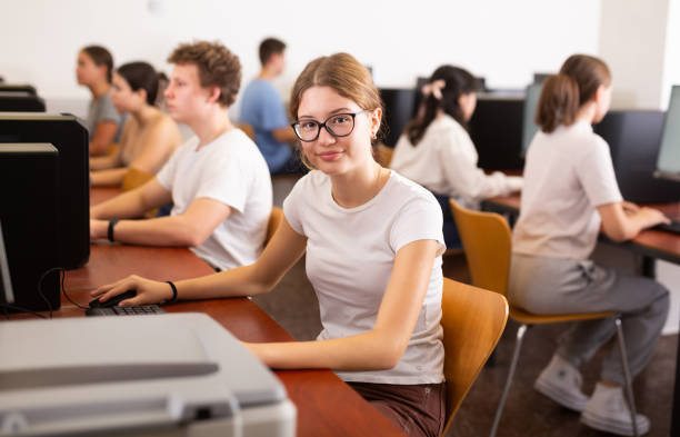 istock Portrait of positive smart girl in computer class 1464594073
