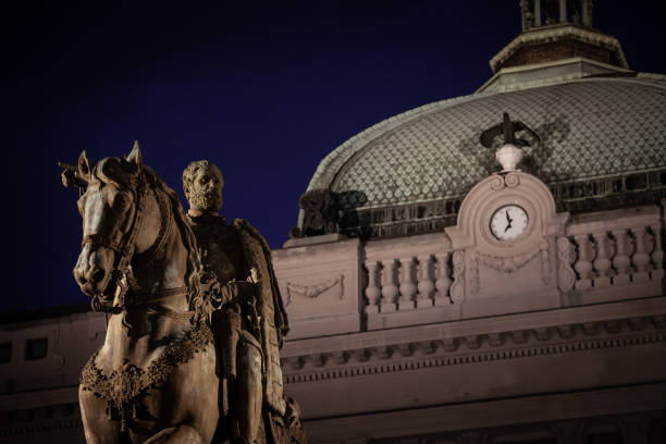 Picture of the national museum of Serbia in belgrade with the statue of Prince Mihailo in front, on Trg Republike, also called republic square at noght with people passing by. Republic Square or Square of the Republic is one of the central town squares and an urban neighborhood of Belgrade, located in the Stari Grad municipality. It is the site of some of Belgrade's most recognizable public buildings, including the National Museum, the National Theatre and the statue of Prince Michael. Prince Mihailo Monument, or Spomenik knezu Mihailu, is a monument of Prince Mihailo. It is located in the main Republic Square in Belgrade, Serbia, and was erected in 1882. It was the first public monument with representation of an equestrian figure of a ruler in Serbia.