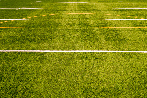 View of empty soccer field without players. Football field with grass and white paint lines and marks. Sports soccer and football with green surface. Recreational activity.