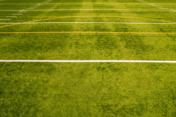 View of empty soccer field without players. Football field with grass and white paint lines and marks. Sports soccer and football with green surface. Recreational activity. stock photo