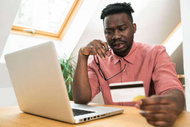 istock Happy man enjoying at home and shopping online 1464599636