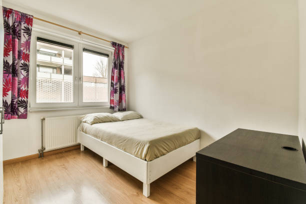 istock a bedroom with a bed and a dresser 1464600097