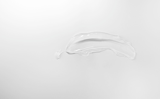 Transparent gel sample smear on white background.
