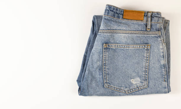 istock Blue jeans lie on a white background, denim texture. 1464601922