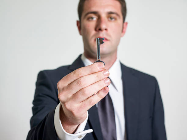 istock Corporate male handing you a key 1464602064